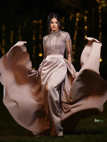 I love capturing movement and grace. This shot was taken outdoors at night, using the ambient light to highlight the flow of the gown. It’s a perfect example of a high-fashion portrait that feels alive and cinematic.