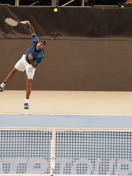 The peak of my jump serve, maximizing height and power.