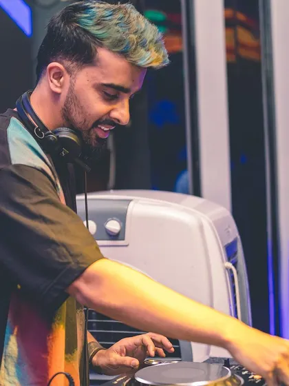 A close-up shot of me focused on the mix, with my unique hair color adding to the artistic vibe. I believe in expressing myself through my look as well as my music.