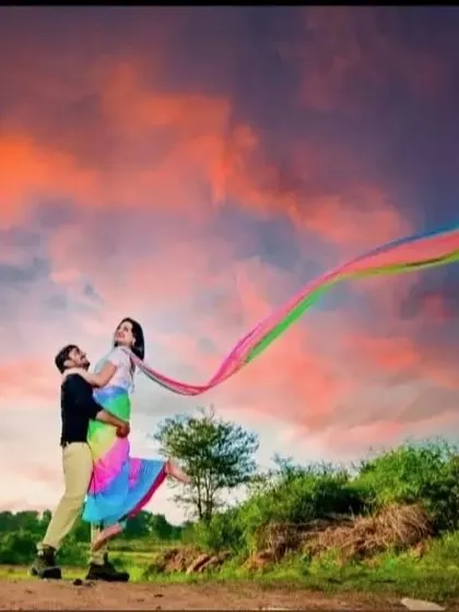 A dramatic shot with a colorful sunset sky. The rainbow trail of the client's outfit creates a stunning visual arc.