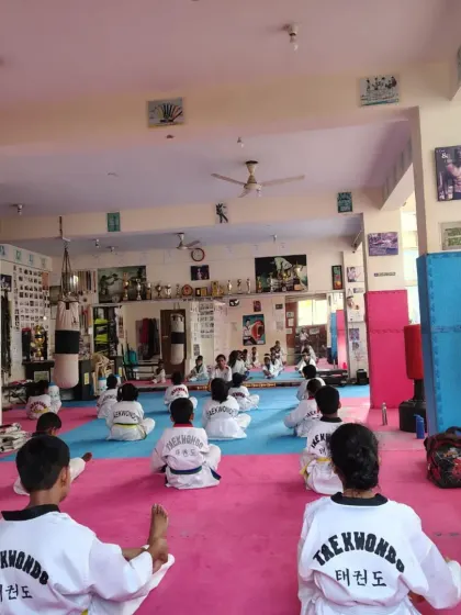 Students practicing a seated stretching exercise.