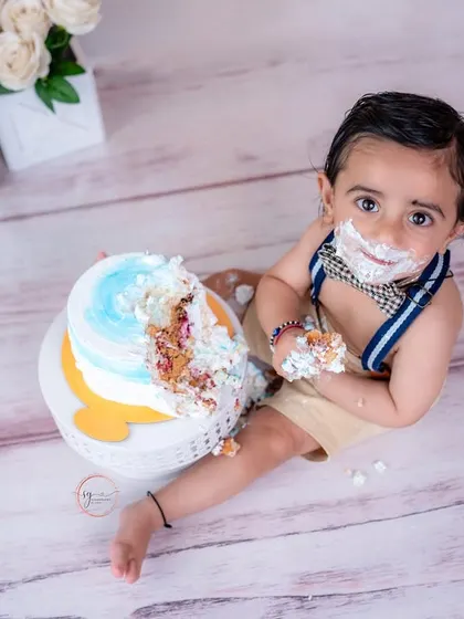 An overhead shot provides a unique perspective of the cake smash, showing just how much fun this little one is having.