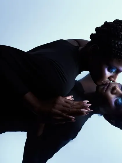 A conceptual shot using a mirror to create a "two-faced" illusion. The pose, with the model kissing her own reflection, explores themes of self-love and identity.