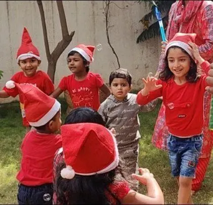 The joy of Christmas celebrations in our garden. Children in Santa hats dancing and playing together, creating wonderful festive memories.