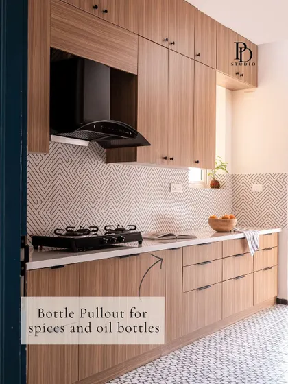 A slim bottle pull-out cabinet next to the stove is a game-changer for Indian kitchens. It keeps everyday oils, sauces, and spices organized and within easy reach while cooking.