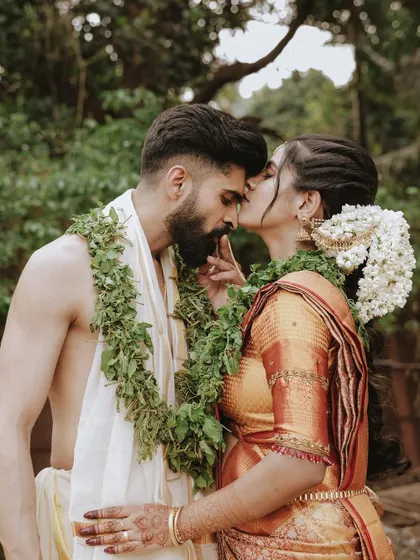 A tender kiss on the forehead, a beautiful and intimate moment between a newly married couple.