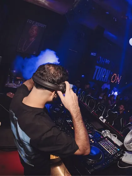 Adjusting my headphones as the CO2 cannon goes off behind me at Toy Room.