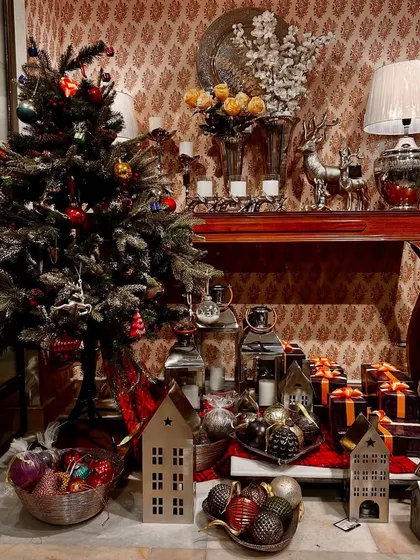 Our store is filled with the warm spirit of Christmas. This corner shows a fully decorated tree, lanterns, and gift-wrapped boxes, creating a festive wonderland.