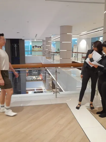 Learning isn't confined to the studio. Here, we are practicing gait analysis in a real-world setting, learning to see how movement patterns translate to everyday life.