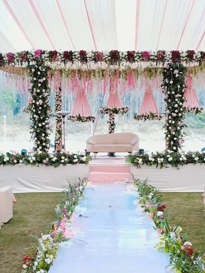 A beautiful pastel-themed mandap set against the riverside backdrop of Wood Castle in Jim Corbett.