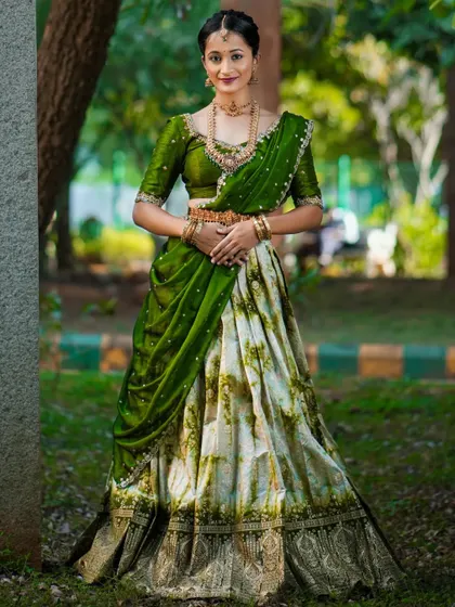 Celebrating growth and harmony with this beautiful green and white half saree.