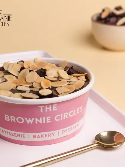 Another look at our Almond Fudge Cake Tub, showcasing the generous topping of toasted almonds and dried fruits over a rich chocolate fudge base.