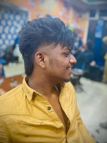 This version of the mullet features a mid-fade and a shorter, choppier texture on top for a younger, more energetic style.