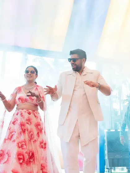 A grand carnival entry for a fun-loving couple. Surrounded by professional dancers in vibrant costumes, their entrance was a burst of energy and color.