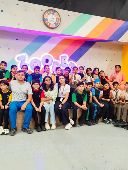 Teachers and students take a moment for a group photo, capturing the memories of a successful school outing.