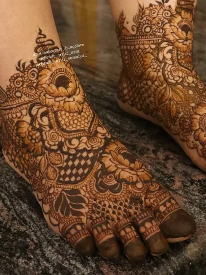 A close up of a detailed bridal foot design, showing the intricate patterns and fine lines.