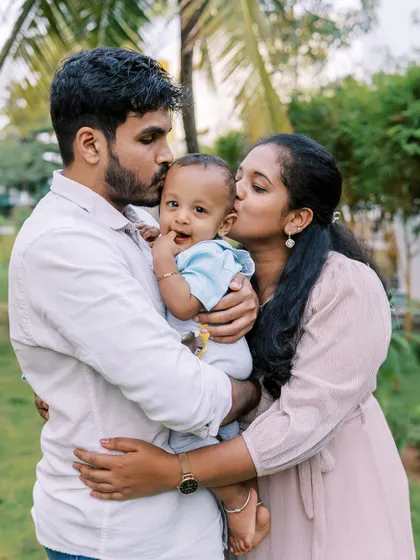 A family sharing a three-way kiss. These moments of affection are the heart and soul of a family photoshoot.