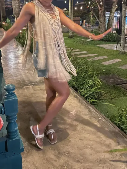 Here I am, enjoying a beautiful evening in my handmade macrame cape. I designed it to be a versatile piece, perfect as a beach cover-up over a swimsuit or styled as a top with shorts for a night out.