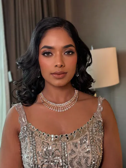 A stunning close-up of Charitha's reception makeup. The warm, bronzy tones on her eyes and skin create a beautiful, cohesive look that enhances her features.