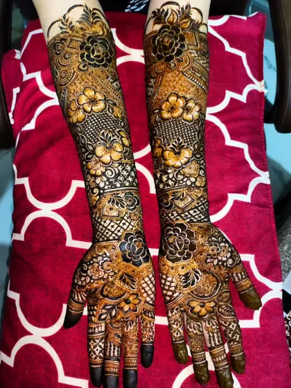 A stunning full-arm bridal design with bold floral motifs. The dark application of the organic henna promises a beautiful, long-lasting stain.