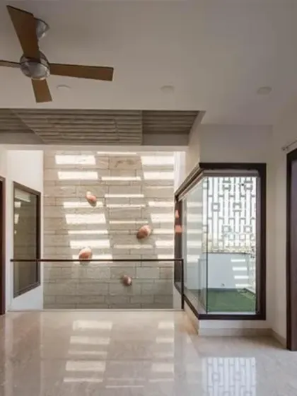 At J House, multiple terraces are designed to enrich the interior experience. This terrace is thoughtfully covered with wooden louvers to create a cozy, semi-private zone, shielded from direct street view.
