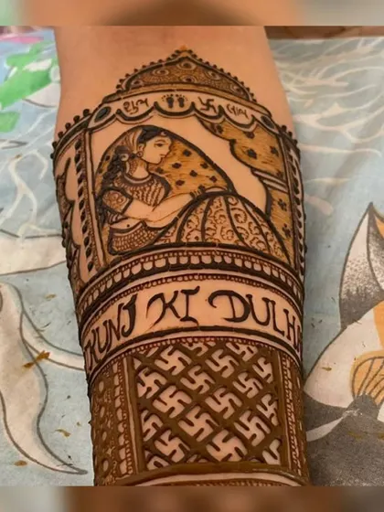 A beautiful depiction of a bride in a doli (palanquin) on the forearm. This traditional scene is a popular request for bridal mehendi, symbolizing the bride's journey to her new home.