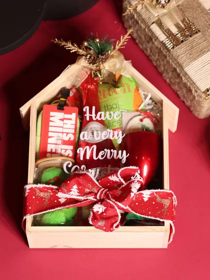 Another angle of the house-shaped Christmas hamper, showing how all the festive items are perfectly arranged inside.