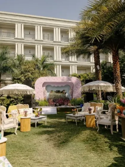 A wide view of the Mehendi setup, showing the various lounge areas and the main stage, all designed with a whimsical, garden-party feel.