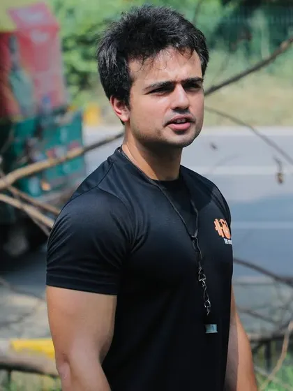 A candid shot of me coaching during our first CrossFit competition. My focus is always on the athletes and ensuring the event runs smoothly.