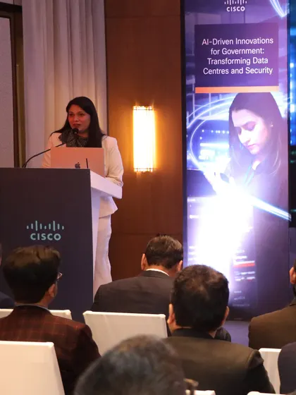 A view from the audience during the Cisco event on AI-Driven Innovations for Government. I ensure the focus remains on the speakers and the content, facilitating a seamless experience for everyone.