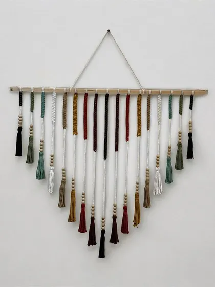 This colorful V-shaped wall hanging is a piece of art for your home. I carefully select each color and knot every tassel by hand to create a vibrant design that brings joy to any room. It's a perfect statement piece for a living room or entryway.