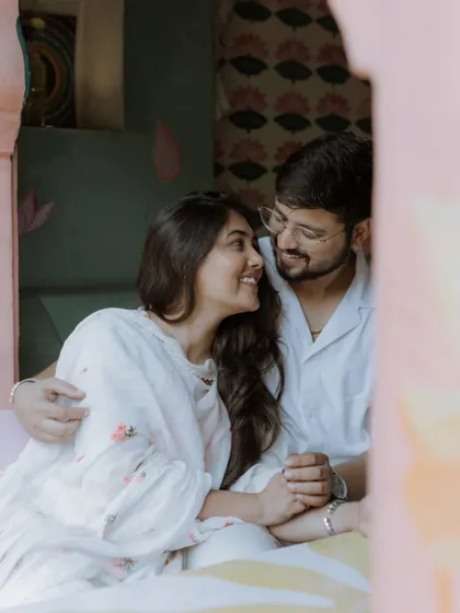 A lovely, natural portrait of the couple sharing a happy, relaxed moment together in a colorful and cozy cafe setting.