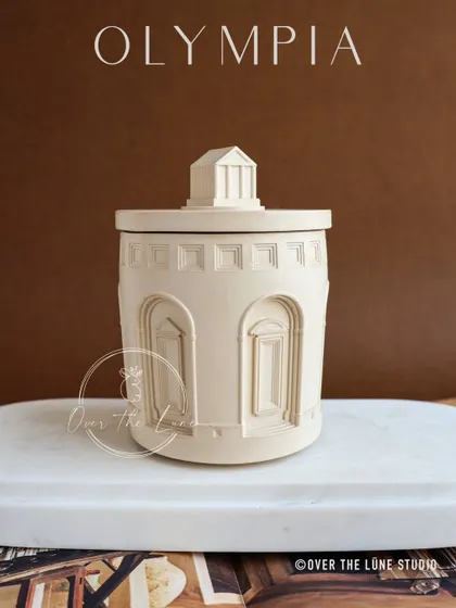 This new Olympia jar features clean lines and arched windows, reminiscent of a Roman temple. It's a versatile piece that works as both a container and a standalone sculpture.
