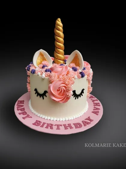 The classic unicorn face cake. This design features buttercream swirls for the mane, sleepy golden eyelashes, and a prominent golden horn.