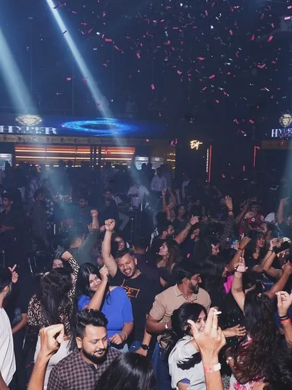 Confetti falls on the energetic crowd at Hyper Club, Raipur. Every night is a celebration.