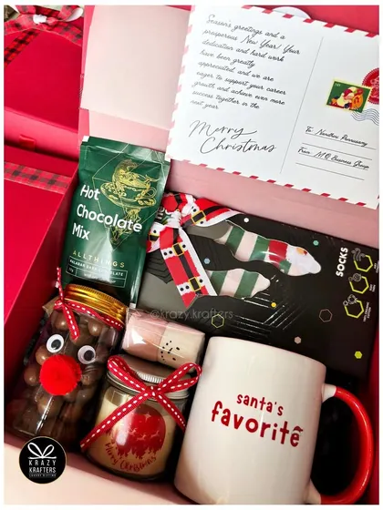A 'Santa's Favorite' Christmas hamper, perfect for a Secret Santa gift, with hot chocolate mix and other festive treats.