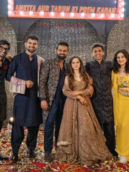 An epic sangeet is incomplete without your friends! The couple and their squad pose in front of the glittering Bollywood-themed stage.