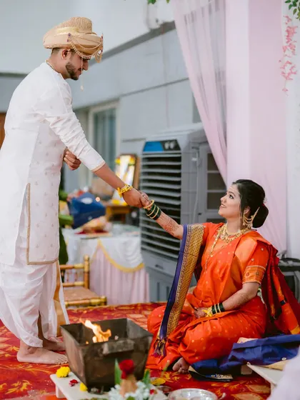 The Saptapadi ritual, with the groom leading the bride around the sacred fire.