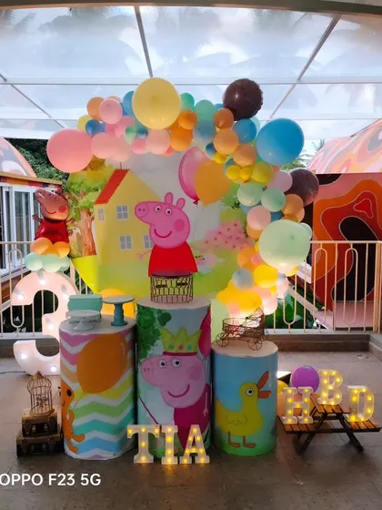 This Peppa Pig theme for Tia's 3rd birthday was so much fun to create. The setup includes a round backdrop with Peppa's house, themed pedestals, and a colourful balloon garland, perfect for a day of jumping in muddy puddles.