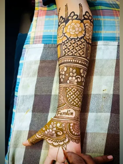 A close-up of the forearm, highlighting the floral band and jaali pattern in this personalized design.