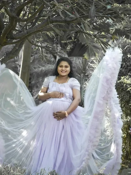 A creative solo portrait using a black and white effect on the background to make the subject and her flowing lavender gown stand out. This technique adds an artistic and dramatic flair.