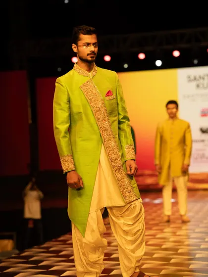 Walking the ramp in a stunning lime green sherwani, showcasing how traditional wear can be both classic and contemporary.