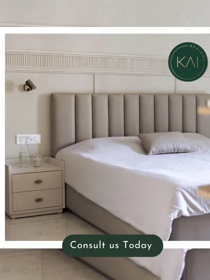 A close-up of a bedroom we designed, featuring a bed with a tall, channel-tufted headboard and matching nightstands. The wall-mounted reading lights add a functional and stylish touch.