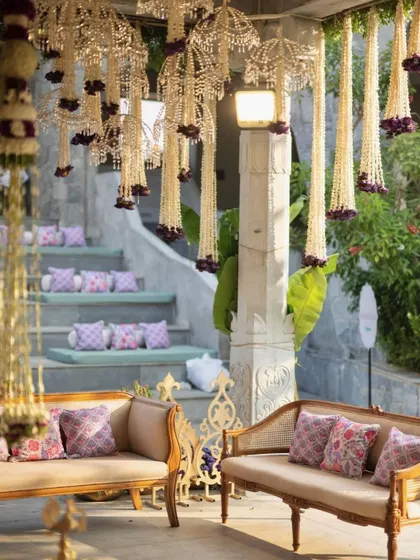 A lounge area at the Muhurtham ceremony, with traditional furniture and custom-printed cushions.