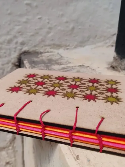 This book features a colorful open spine binding and a laser engraved star pattern on the cover.