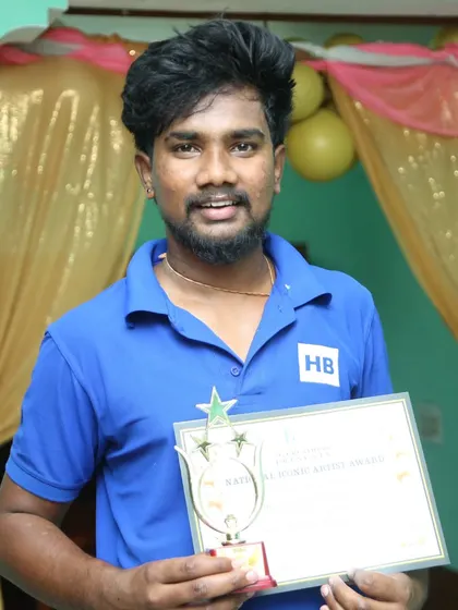 A team member proudly holding our trophy and certificate for the National Iconic Artist Award.