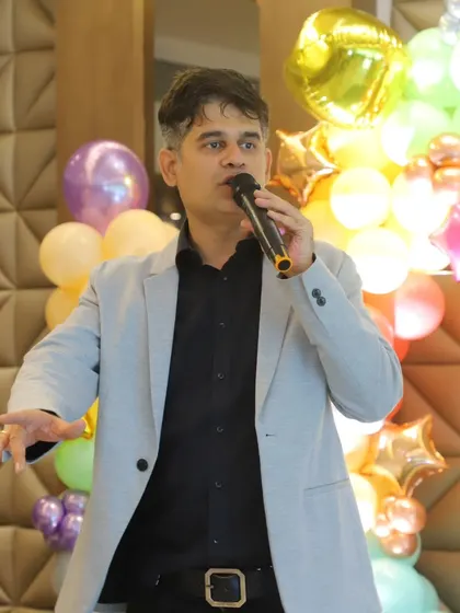 Commanding the stage and the crowd. A good emcee knows how to capture everyone's attention and guide the party smoothly.