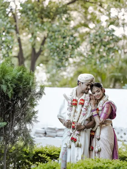 A sweet, romantic moment between the couple. The bride's makeup is soft and natural, perfect for these candid, heartfelt photographs.