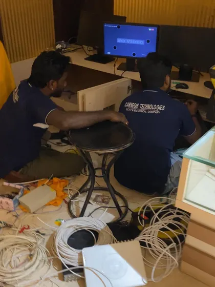 Here, my technicians are configuring a CCTV monitoring station for a commercial client. We handle the entire setup, from running cables to programming the system, ensuring all cameras are recording and accessible.