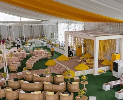 The overall setup for the Haldi in Kochi, designed as a relaxed garden party with lounge seating and a central stage.